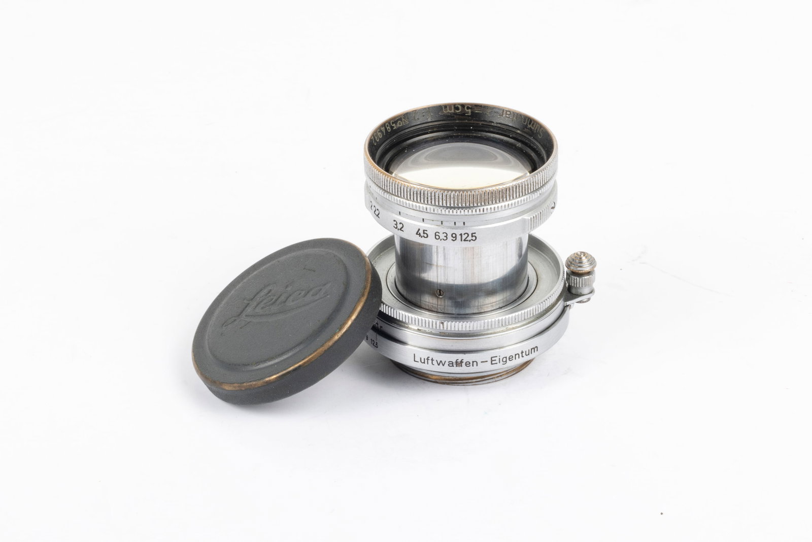50mm Summitar f2 Luftwaffen-Eigentum Nr. 584932: 50mm Summitar f2 Luftwaffen-Eigentum Nr. 584932. Made in 1944 for the German Air Force and engraved “Luftwaffen-Eigentum,” this lens has its original, grey painted lens cap.Condition: