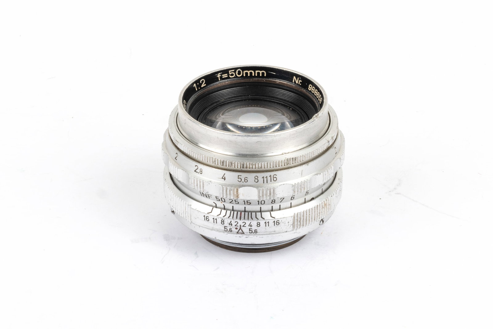 Steinheil München 50mm Quinon f2: Steinheil München 50mm Quinon f2 Nr. 988658 in original Leica screw mount. Optics show haze appropriate to age as well as prominent cleaning marks. Condition: Very Good