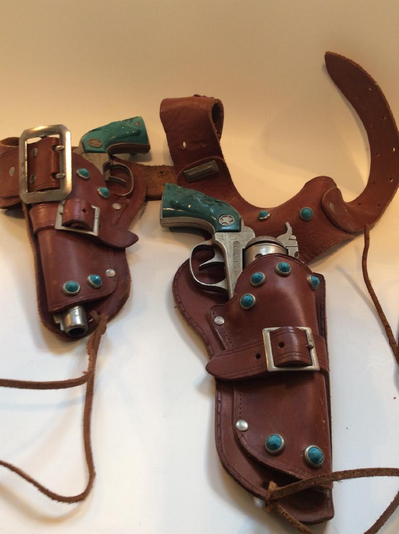 Colt 38 Cowboy Cap Gun Set: Colt 38 Cowboy Cap Gun Set - Turquoise on holsters and pistol handles. 1950s. No cracks in the frames or handles, and both trigger/barrel actions work solidly. Not tested with caps. We have caps in th