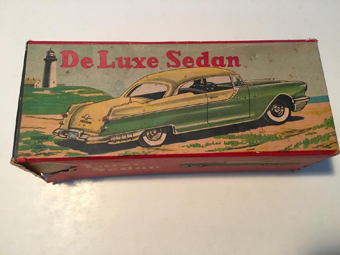 VINTAGE TIN TOY - De Luxe Sedan - ASAHI TOY: VINTAGE TIN TOY - De Luxe Sedan. Amazing paint quality with limited issues. Box is intact with missing side panel. Pontiac car. Asahi Toy Company / Asahi Gangu Seisakusho. Tokyo, Japan. Founded in 194