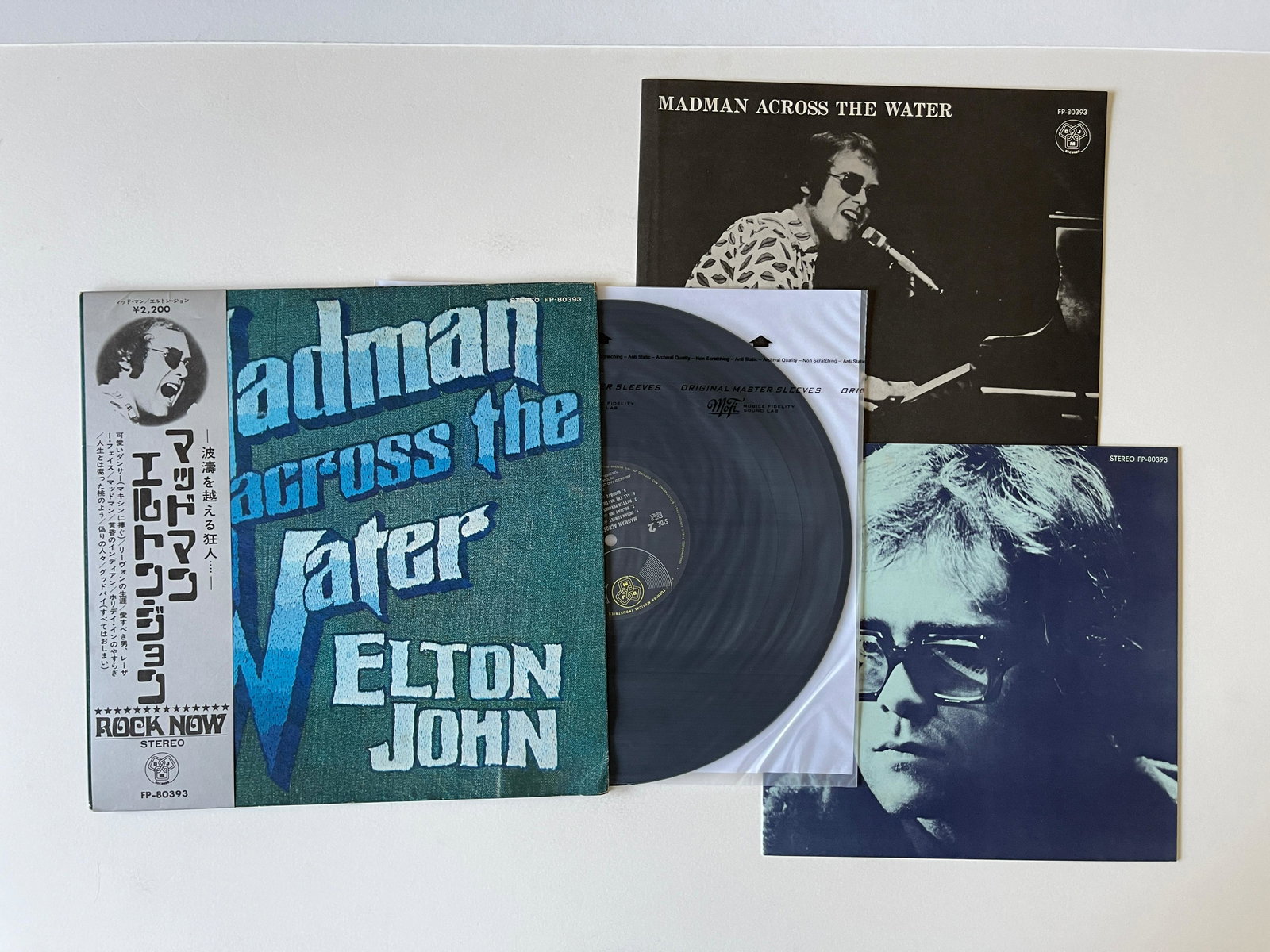 Elton John - Madman - JAPAN: Elton John - Madman Across The Water: (FP-80393) VG++/VG+ (1971, Â¥2,300 2nd Press Gatefold LP with OBI, 2 Inserts, and Booklet, Back of OBI has a little foxing) $46