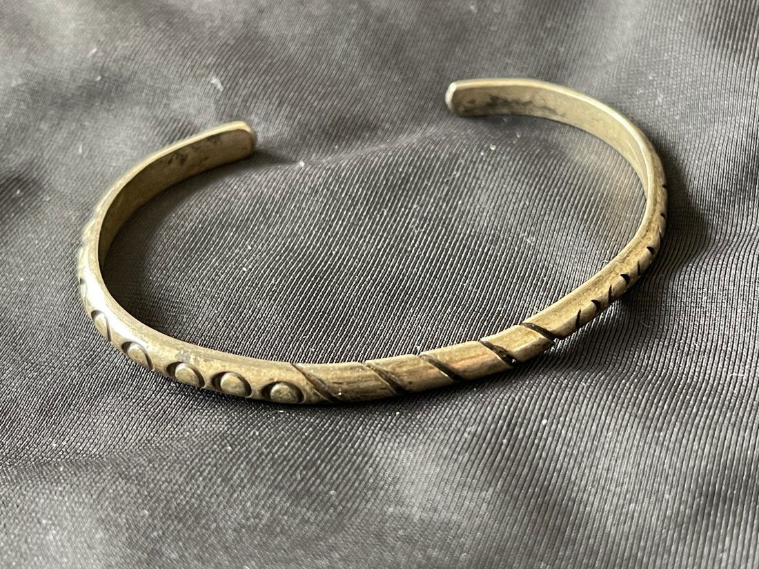 SMALL DETAILED SILVER CUFFED BRACELET: SMALL DETAILED SILVER CUFFED BRACELET. Semi-circle horseshoe shaped symbols and lines etched into the face of this simple bracelet make it a daily wearer. Weight: 9.3gm