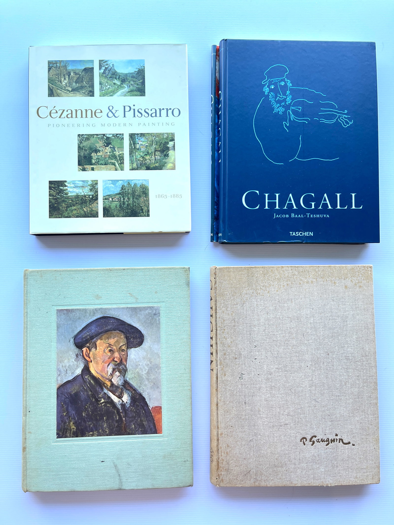 FOUR BOOKS ON THE OLD MASTERS OF ART: FOUR BOOKS ON THE OLD MASTERS OF ART FEATURING CEZANNA & PISSARO. CHAGALL, AND Paul Gauguin, WITH TIPPED IN ART.