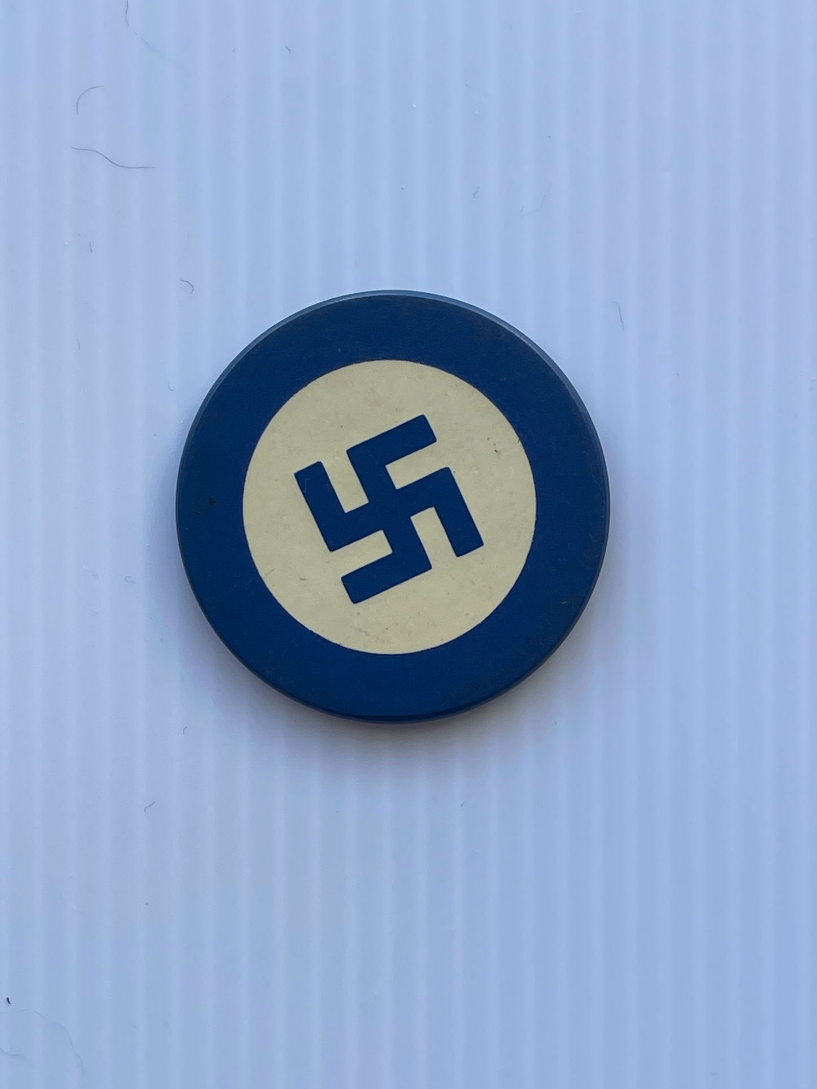 WHIRLING LOG BLUE CLAY POKER CHIP: Not Nazi Swastikas, but Pre WWII the swastika was known as whirling logs, a symbol of good luck in Native American Culture. The symbol was renounced in the 1940's due to Hitler's desecration of the sy