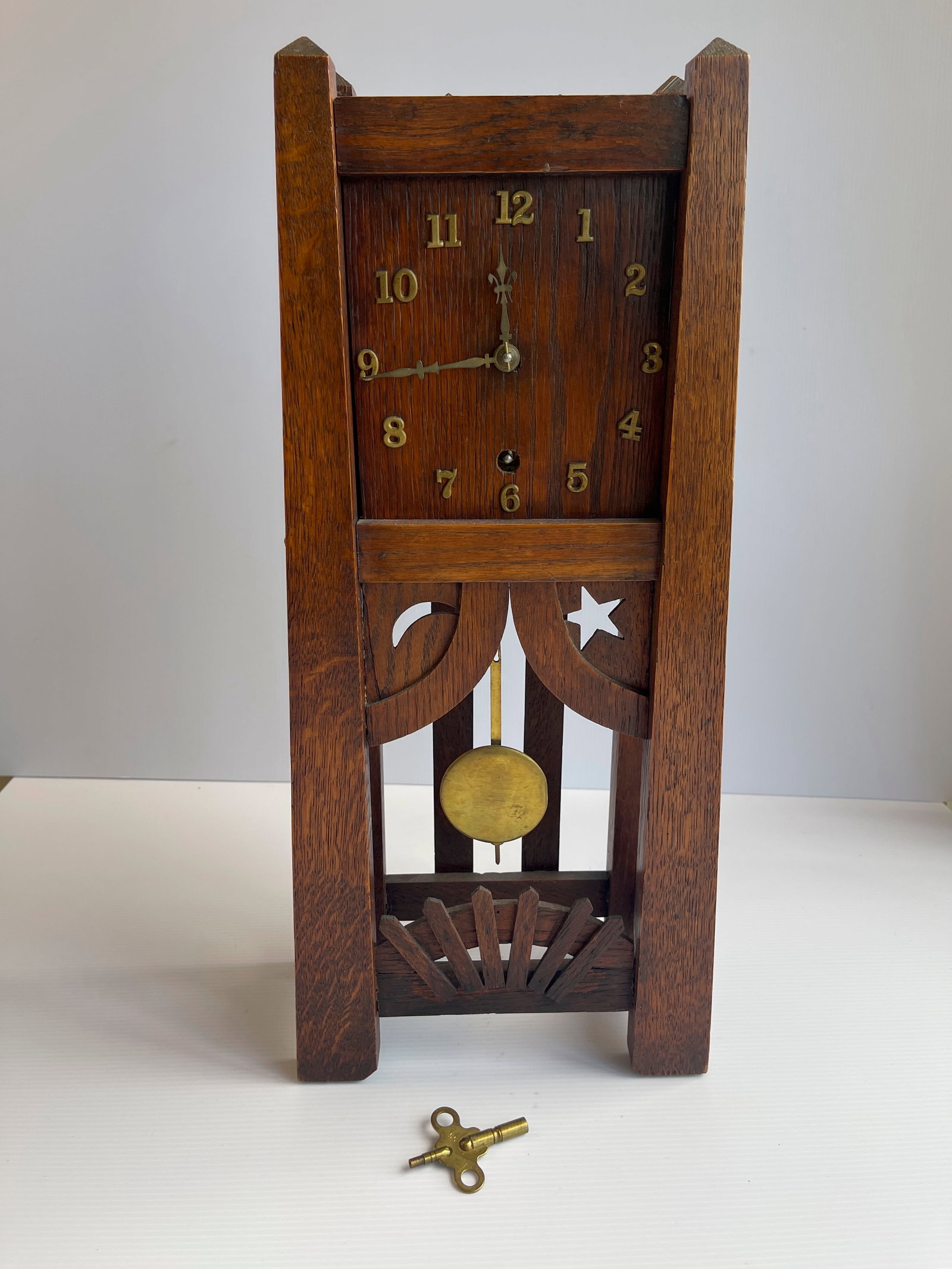 EXQUISITE MISSION OAK MANTLE CLOCK WITH UNIQUE DECORATIVE MOTIFS: EXQUISITE MISSION OAK MANTLE CLOCK WITH UNIQUE DECORATIVE MOTIFS. CIRCA 1910. LABEL ON REVERSE READS MISSION KK. MANUFACTURED BY GILBERT CLOCK CO. NEW YORK, CHICAGO, SF, ST. LOUIS. CLOCK WORKS. COMES 
