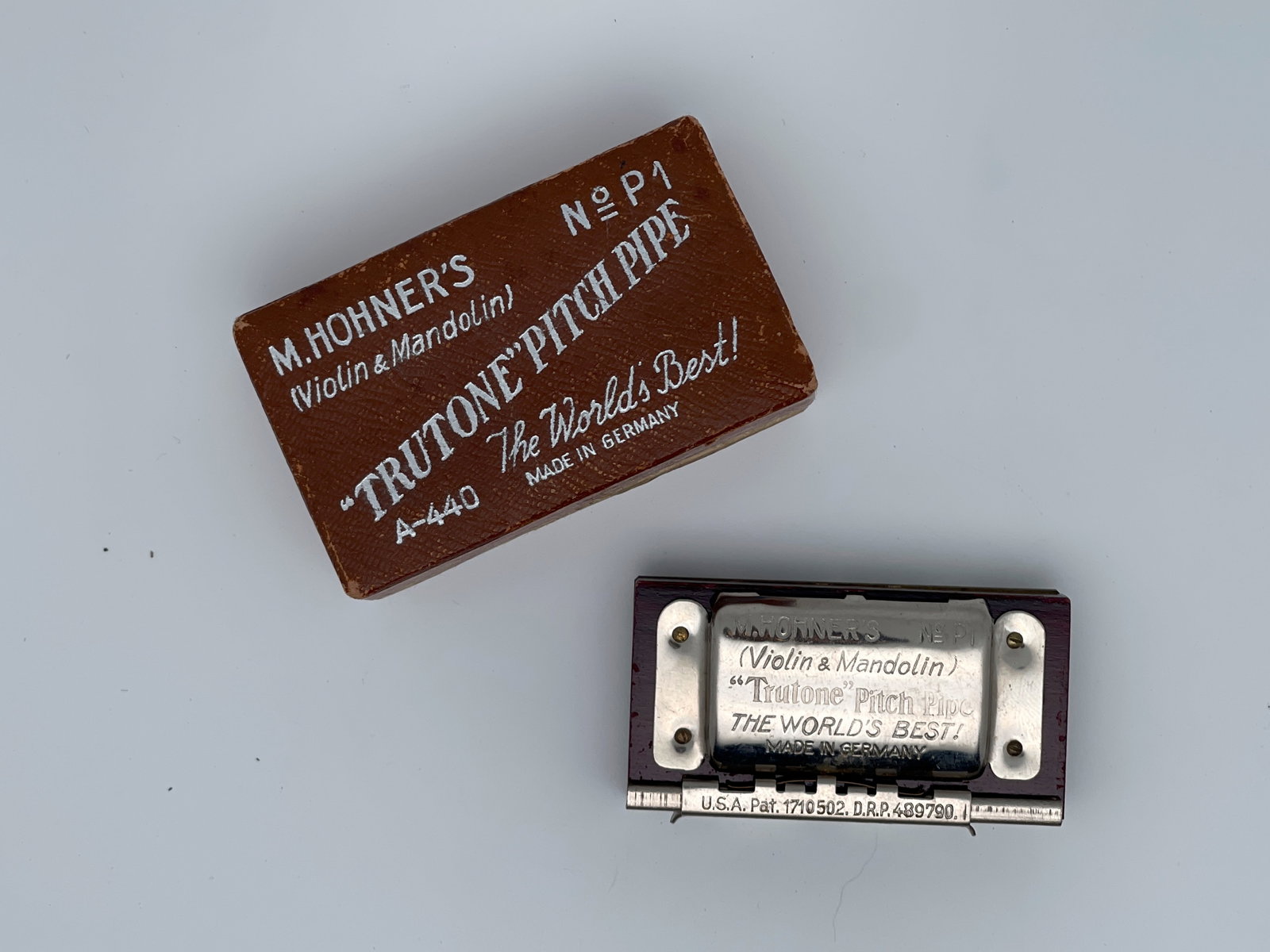 M. Hohner's "Trutone" Pitch Pipe for violin and mandolin: The image shows a vintage M. Hohner's "Trutone" Pitch Pipe for violin and mandolin, made in Germany. A pitch pipe is a small device that provides a reference pitch for musicians to tune their instrume