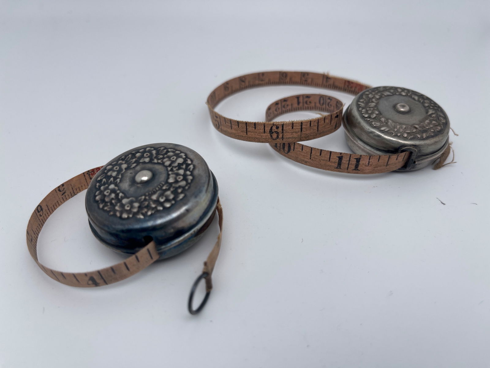 TWO VINTAGE STERLING TAPE MEASURES: TWO VINTAGE STERLING TAPE MEASURES. BOTH MARKED WITH STERLING STAMP. BOTH WORK. ONE HAS TORN TAPE END.
