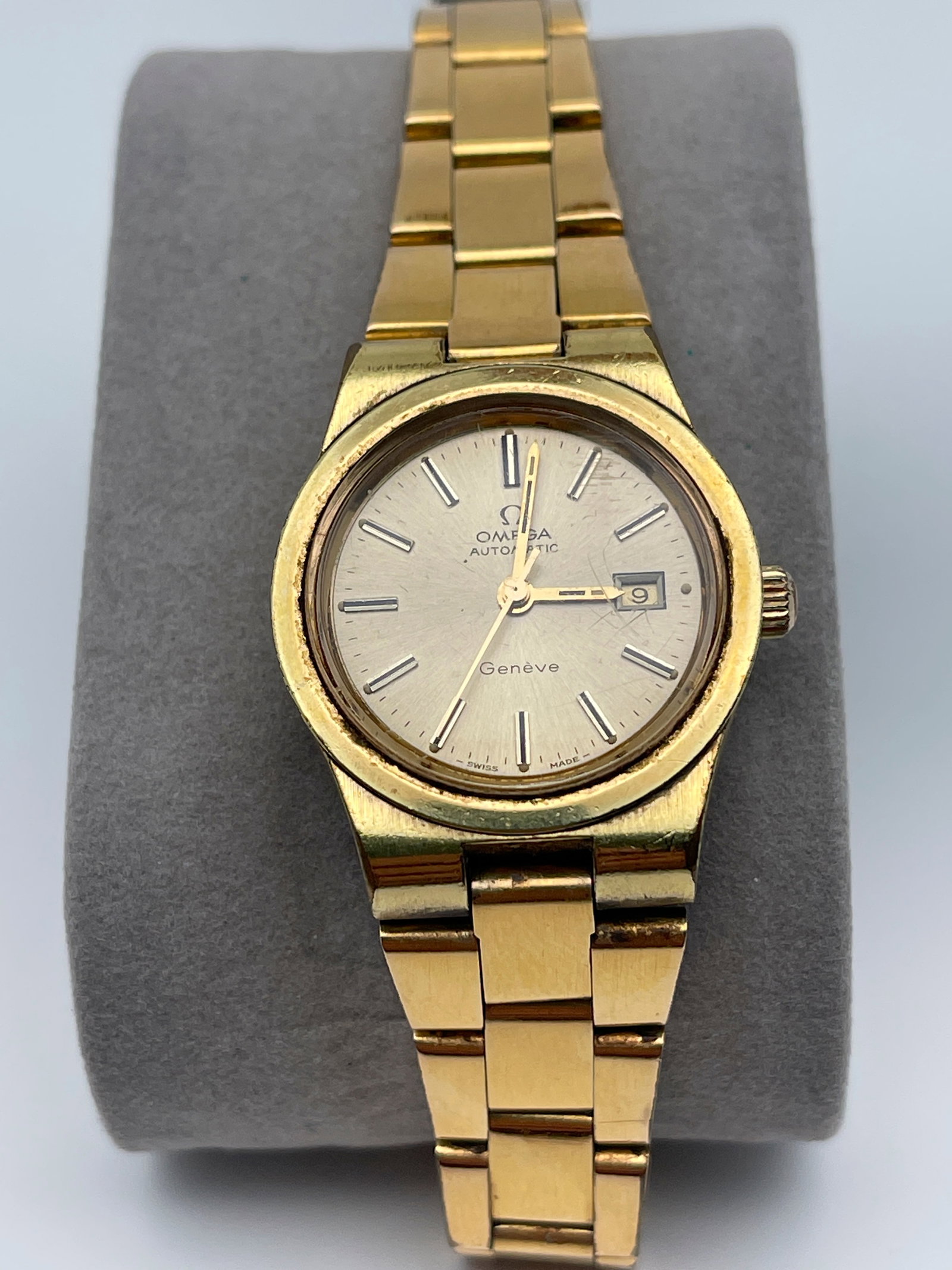 VINTAGE OMEGA LADIES SWISS WATCH - CIRCA 1970’s: VINTAGE OMEGA LADIES SWISS WATCH - CIRCA 1970’s. Stainless steel plated gold. Sold as is. Hands and date move freely. Second hand sweeps. Gold band. Screw down caseback. Looks fully functional but s
