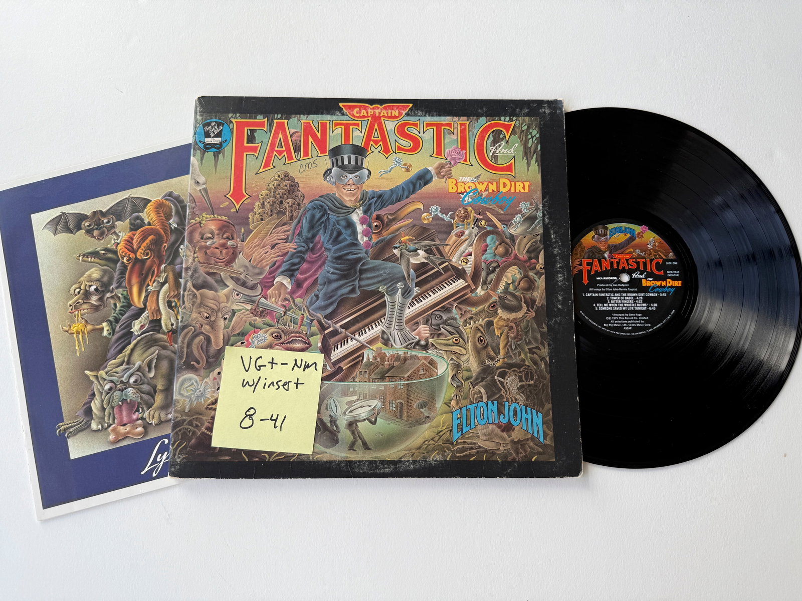 Elton John - Captain Fantastic And The Brown Dirt Cowboy: Elton John - Captain Fantastic And The Brown Dirt Cowboy. MCA Records - MCA-2142. With "Lyrics" book