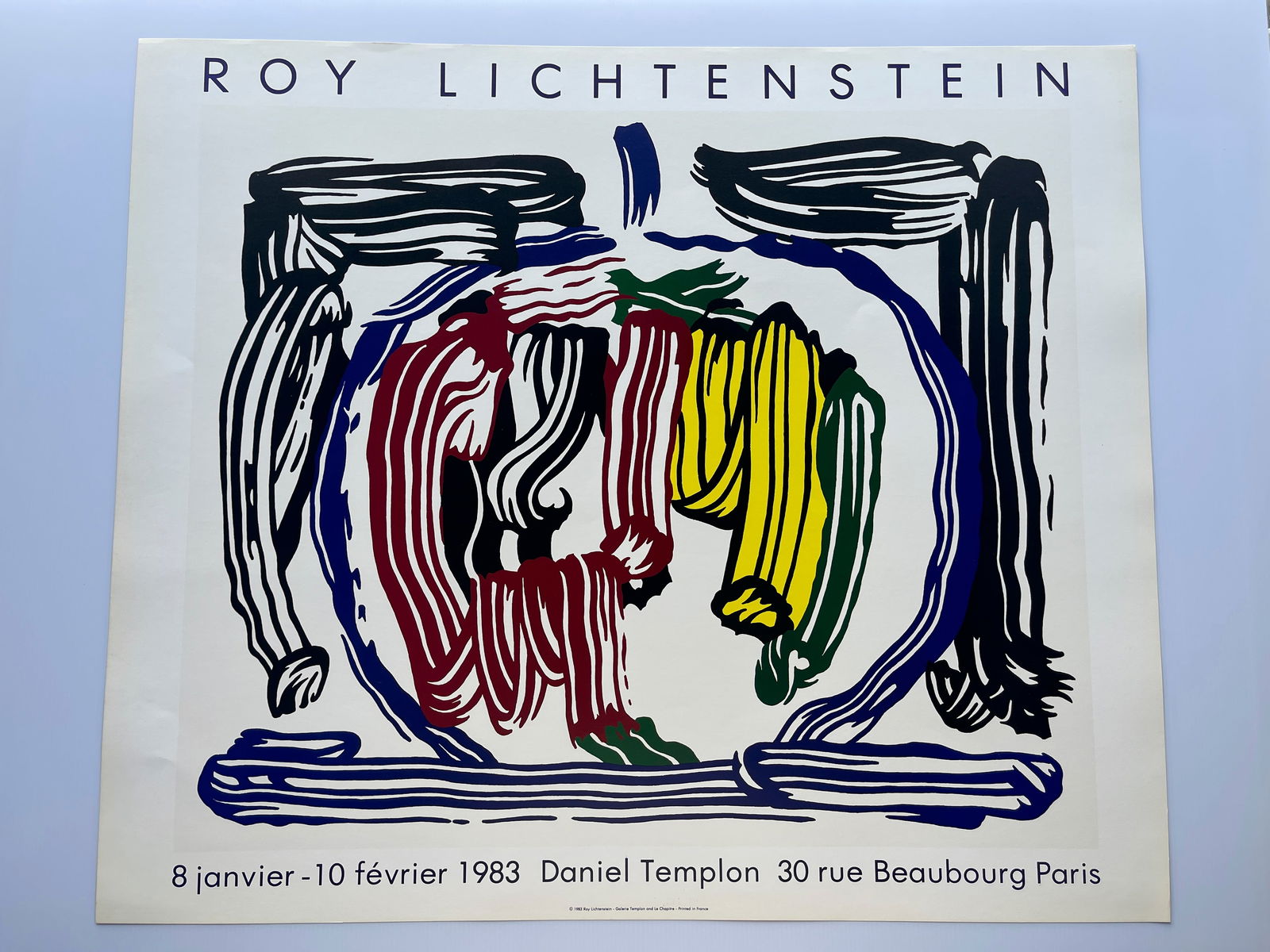 Roy Lichtenstein - Brushstroke Still Life with Apple: The image provided is a vintage exhibition poster for a Roy Lichtenstein show at the Galerie Daniel Templon in Paris in 1983. The specific artwork featured on the poster is titled "Brushstroke Still L