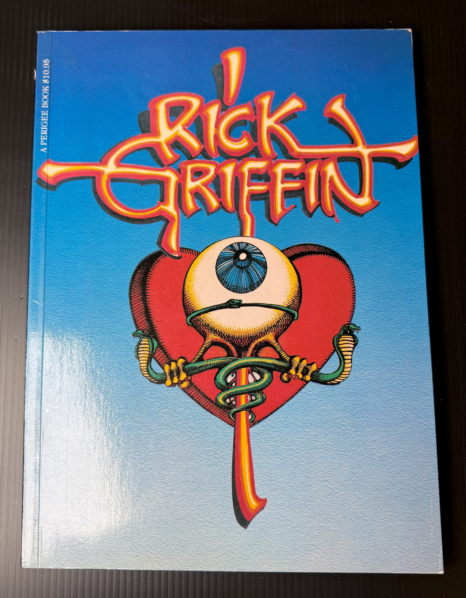 RICK GRIFFIN SIGNED ART BOOK: RICK GRIFFIN SIGNED ART BOOK. 1980 FIRST EDITION. Rick Griffin began his career drawing for Surfer and Hot Rod Cartoons. By the mid-1960s, his work was appearing in posters designed for the Fillmore a