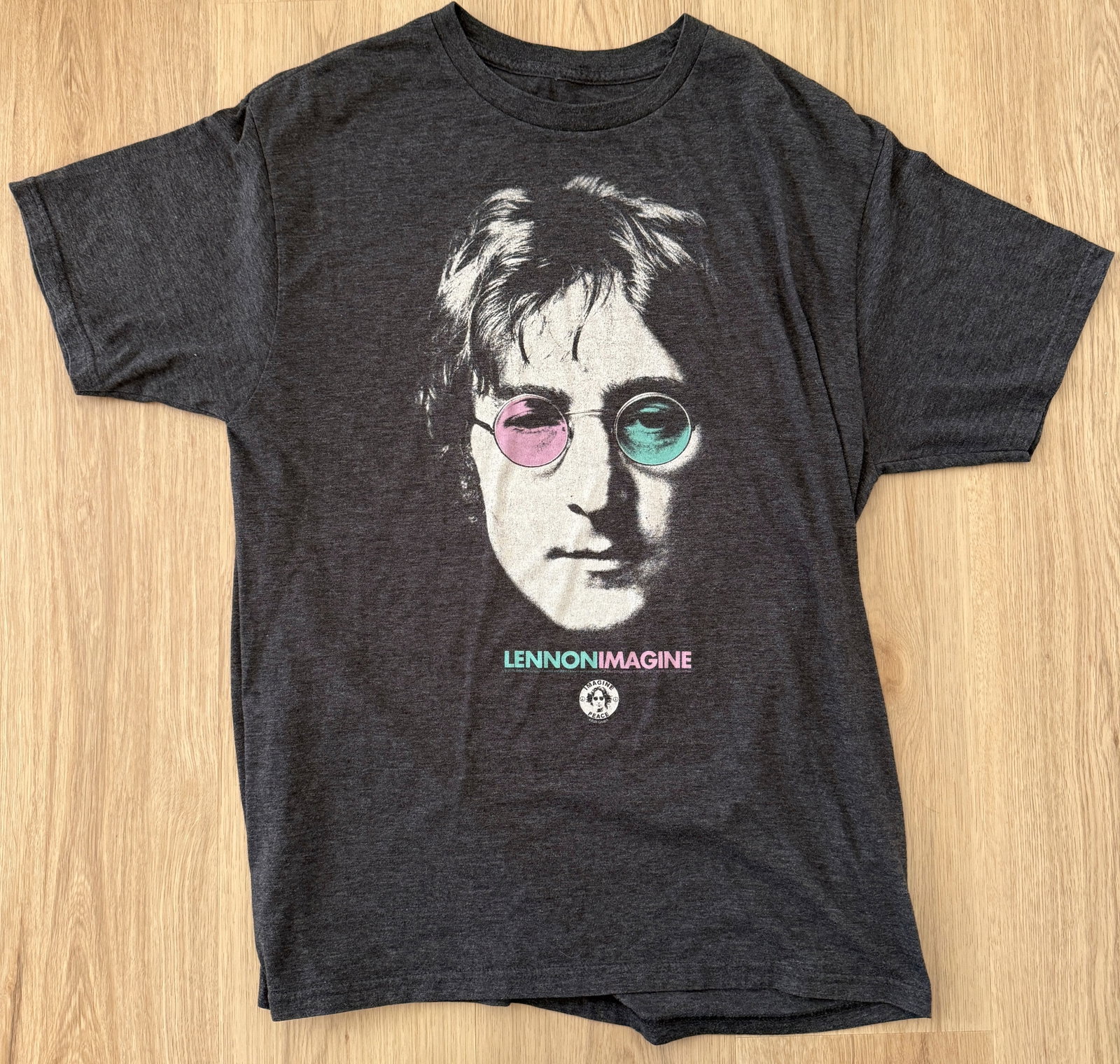 JOHN LENNON IMAGINE T-SHIRT: JOHN LENNON IMAGINE T-SHIRT. NO TAG. LOOKS LIKE WOMENS MEDIUM. SHORT SLEEVE. SINGLE SIDED GRAPHICS.
