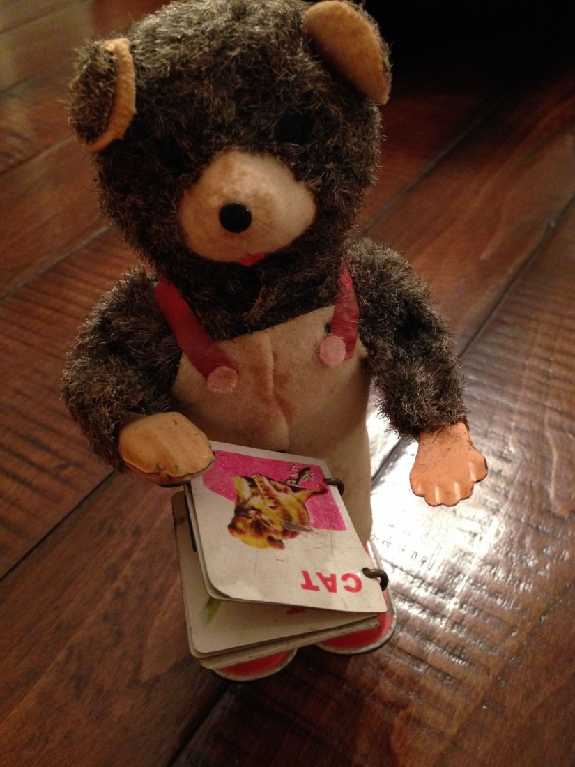 WIND UP TIN TOY FROM JAPAN P READING BEAR: WIND-UP TIN TOY FROM JAPAN P READING BEAR. Works = needs tuning and grease. When working the bear flips the metal pages of the book with one hand and after a few pages he flips them back to start agai