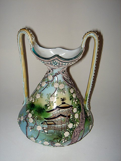 Unusual Nippon Moriage Ewer ca1890: A NIPPON GREEN, MORIAGE TWO-HANDLED EWER. This extraordinary Nippon ewer is in very good condition, with what looks like a repair at the handle which was discovered under a black light. The ewer measu
