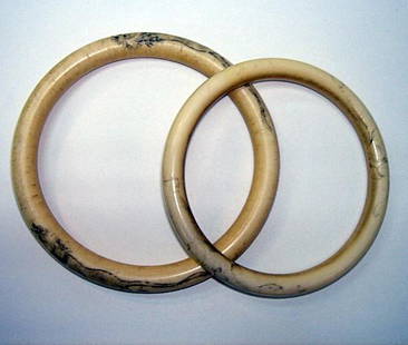 Pr Chinese Ivory Bangles Tiger Motif ca1890: A PAIR OF CHINESE IVORY DRAGON MOTIF BANGLES These bangles measure 3.5" and 3" in diameter and one has a tiger motif and the other an elephant motif carved on it, though this is now only faintly seen.