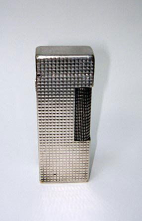Swiss Dunhill Sterling Silver Rollagas Lighter: A DUNHILL STERLING CIGARETTE LIGHTER This lighter measures 2.5" in height and was produced in Switzerland. It is intact apart from a flint.
