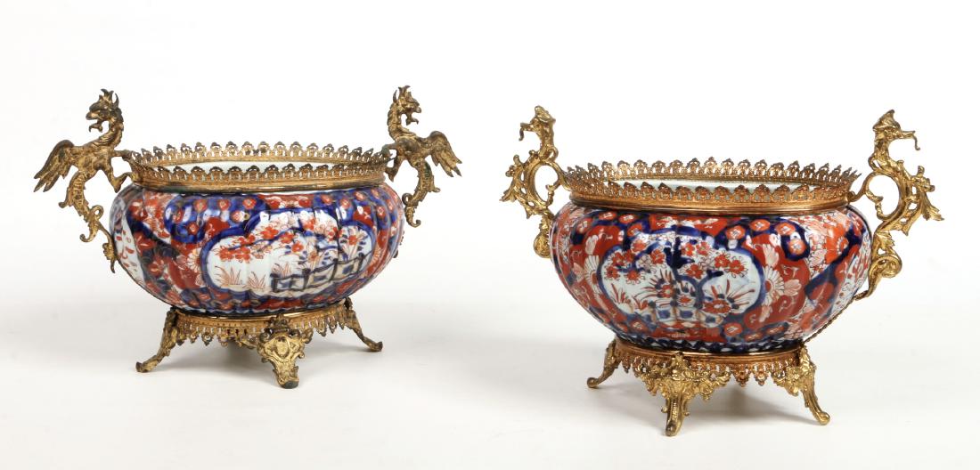 A near pair of Japanese late Meiji period fluted Imari: A near pair of Japanese late Meiji period fluted Imari ovoid planters with later French ormolu mounts, 40cm wide.