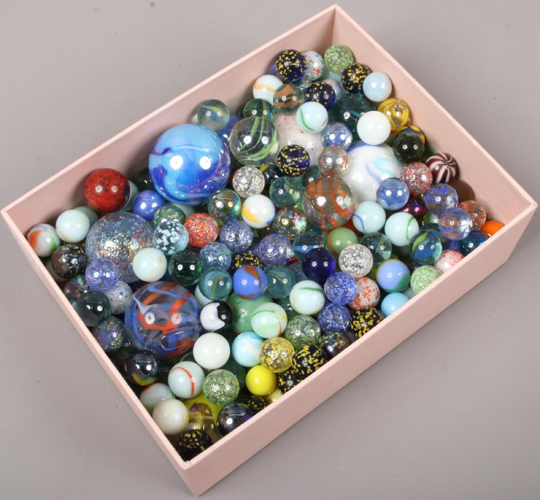 A box of glass marbles.: A box of glass marbles.