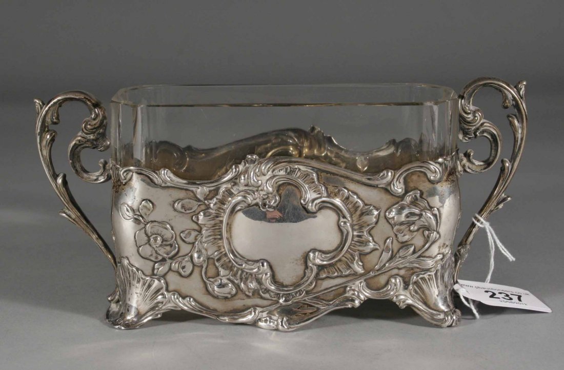 A German Art Nouveau silver and cut glass twin han: A German Art Nouveau silver and cut glass twin handled posy vase by Lutz & Weiss, 8.5'' wide.