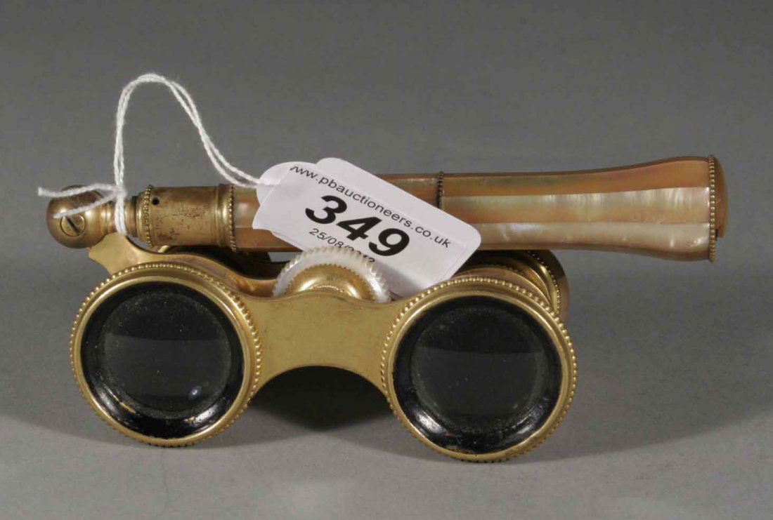 A pair of brass and mother of pearl opera glasses: A pair of brass and mother of pearl opera glasses with folding handle.