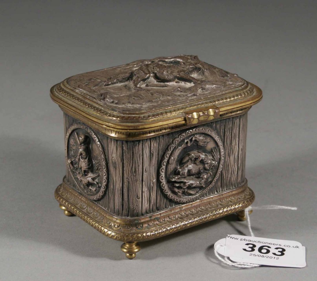 A nineteenth century continental white and yellow : A nineteenth century continental white and yellow metal jewel casket, decorated with embossed hunting scenes, 3.5'' wide.