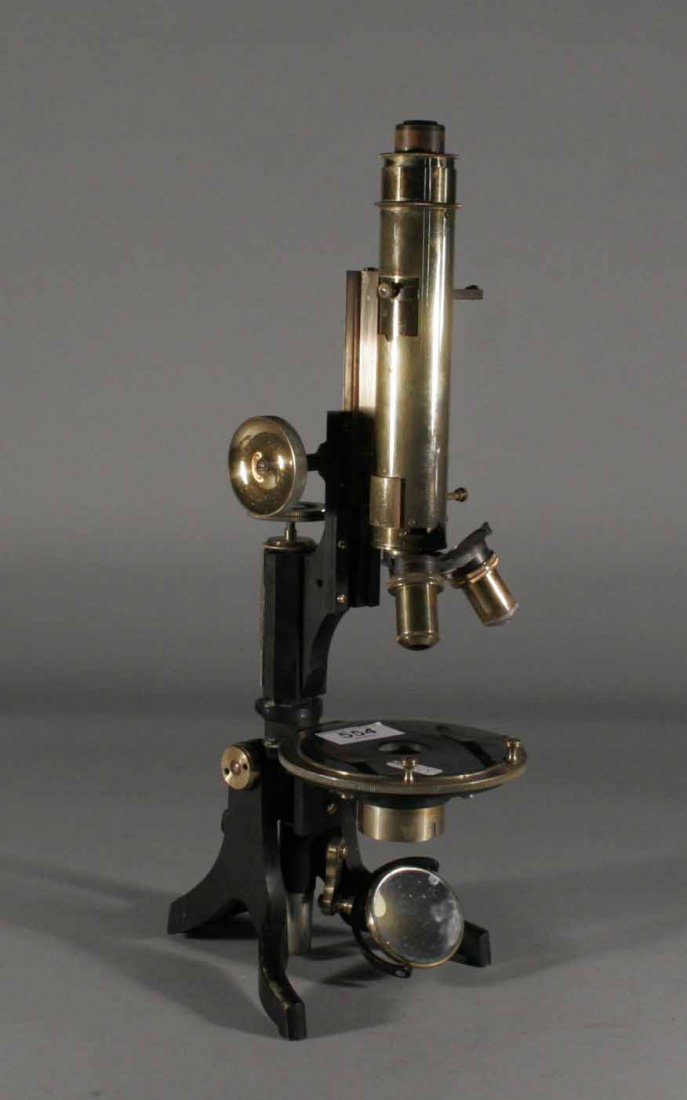A swift petrological brass microscope on black lac: A swift petrological brass microscope on black lacquered stand, 17''.