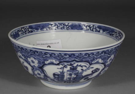 A Chinese slop bowl, decorated in underglaze blue wi: A Chinese slop bowl, decorated in underglaze blue with shaped reserves containing precious objects, four character mark and period, 5.75'' diameter.