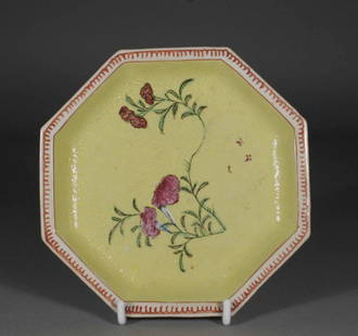 An eighteenth century Chinese octagonal saucer yello: An eighteenth century Chinese octagonal saucer yellow ground with Sgraffito style decoration and enamelled with flowers, 6'' wide.