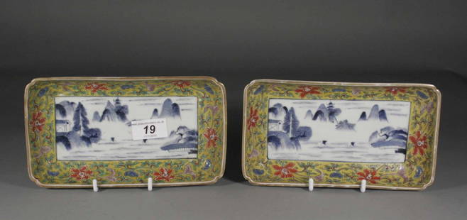 A pair of nineteenth century Chinese dishes of rect: A pair of nineteenth century Chinese dishes of rectangular form, decorated to the centre in underglaze blue with river landscapes and with yellow ground borders enamelled with stylized flowers, six