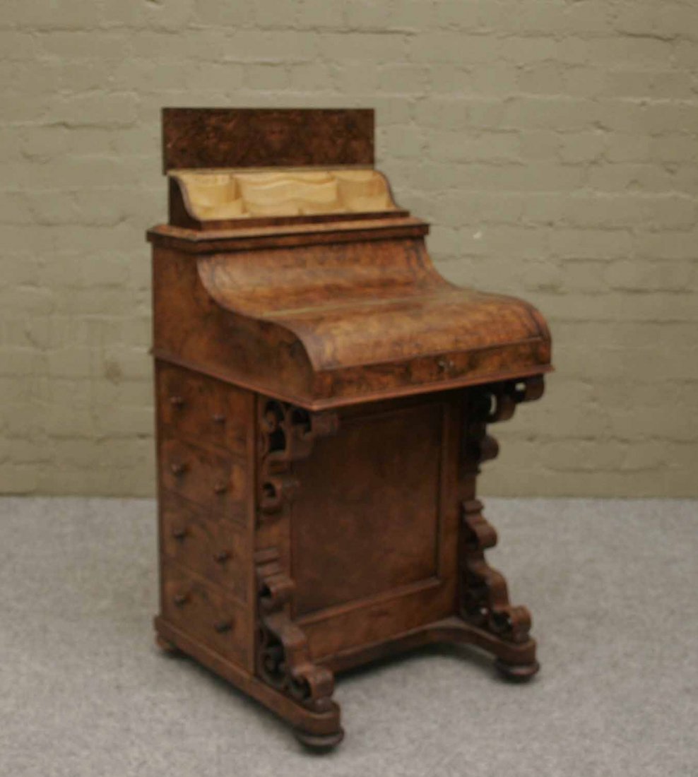 A Victorian bur walnut piano top Davenport with fi: A Victorian bur walnut piano top Davenport with fitted interior and jack in the box stationary comportment, 35''.