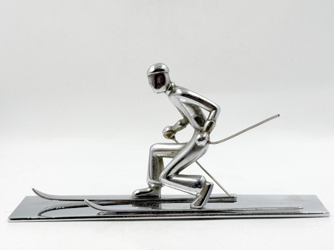 Atelier Hagenauer Art Deco Bronze Figure "The Skier" H: 4" W: 6" D: 2": Shipping In - House available. Carl Hagenauer (1872 - 1928) founded what became the Werkstatte Hagenauer Wien in 1898. He began as an apprentice at Wurbel & Czokally, a silverware producer in Vienna. 
