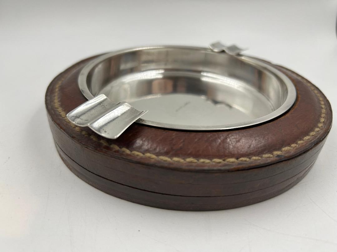 Hermes Paris Leather & Metal Art Deco Ashtray H: 1" Diam: 5.3" France: We have an in-house shipping department to ensure your post-purchase processing is as easy as possible. We encourage you to call us 561-2129413 or contact carstensgalleries@yahoo.com if you have any f