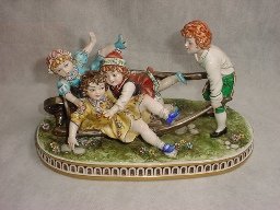 Capodimonte Porcelain, signed by artist, Num 168: Children playing with cartwheel, H - 7" W - 12" D - 6" Est. Shipping = $40 to U.S