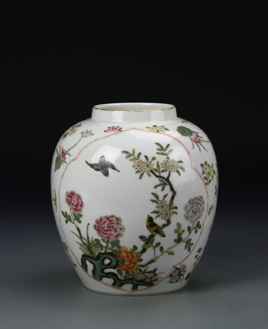 Chinese Famille Rose Jar: China, 19th C., Famille Rose jar, on a flat base, with high rounded shoulders, painted with a brightly hued image of flowers and plant life, Qianlong mark. Height 7 1/2 in.