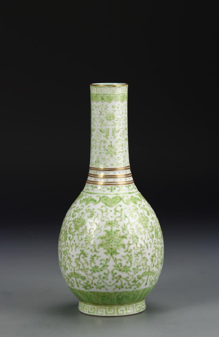 Chinese Famille Rose Vase: China, 19th century, green Famille Rose vase, on a raised base, in an oval form, with a long, narrow neck and flat rim, delicately glazed with a pale green pattern over a white ground, with Dao Guang 