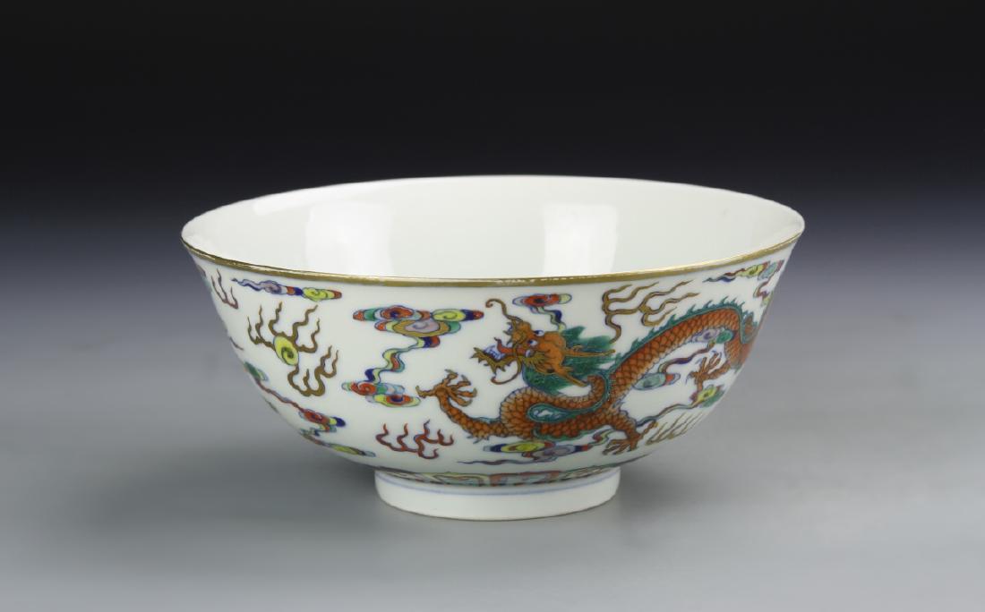 Chinese Doucai Bowl: China, Qing period, flared sides on footed base, painted with colorful dragon and symbols throughout with a plain interior, Yongzheng mark on base. Diameter 6 1/2 in., Height 2 3/4 in.