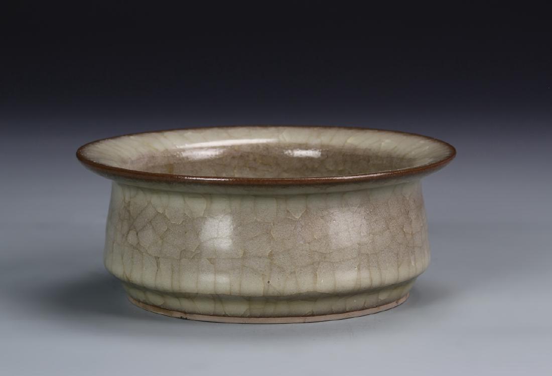 Chinese Ice Crackled Brush Washer: The tapered sides resting on a canted foot, and rising to a wide everted rim, covered allover with a mottle pale amber glaze suffused with dense network of ice-flake crackles, 6.3 in wide. Provenance: