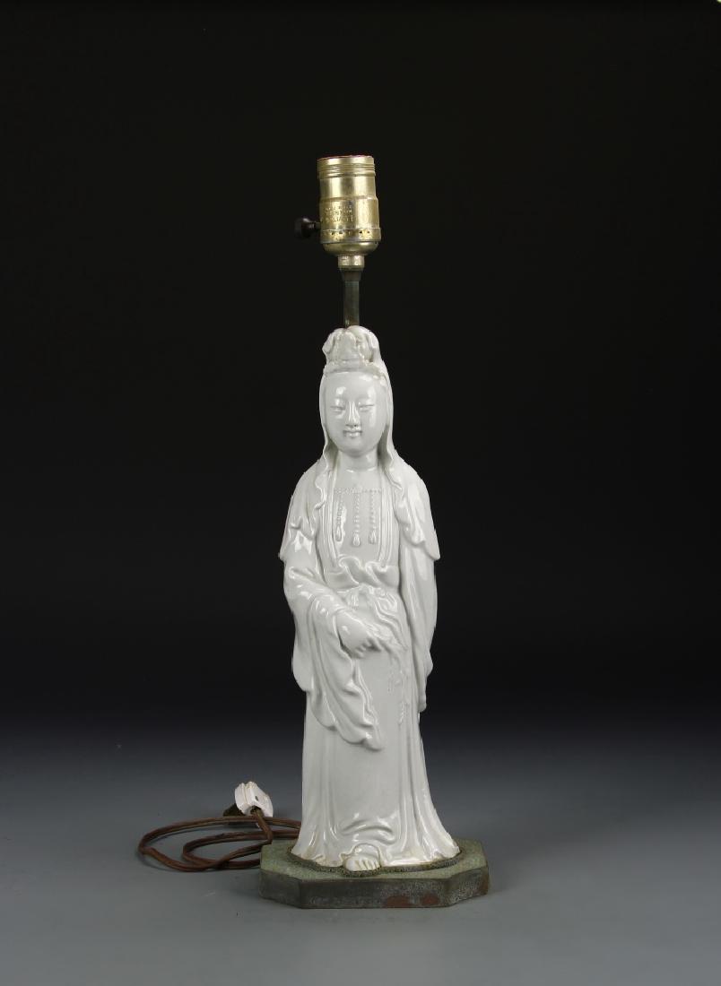 Chinese Blanc de Chine Guanyin Lamp: China, 19th C., Blanc de Chine Guanyin, standing barefoot wearing simplistic robes with detailing in the necklaces and a draped headdress, mounted as a lamp. Height 12 1/4 in.