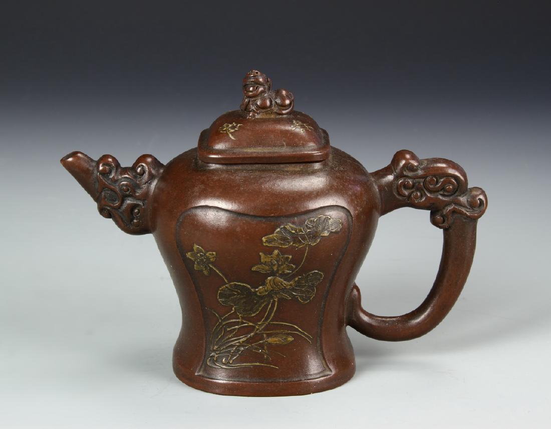 Chinese Yixing Teapot: China, ROC, Yixing teapot, bean shaped body with undulating sides to flat base, dragon formed spout and handle with fitted lid featuring a foo lion finial, mark on base. Height 5 1/8 in.