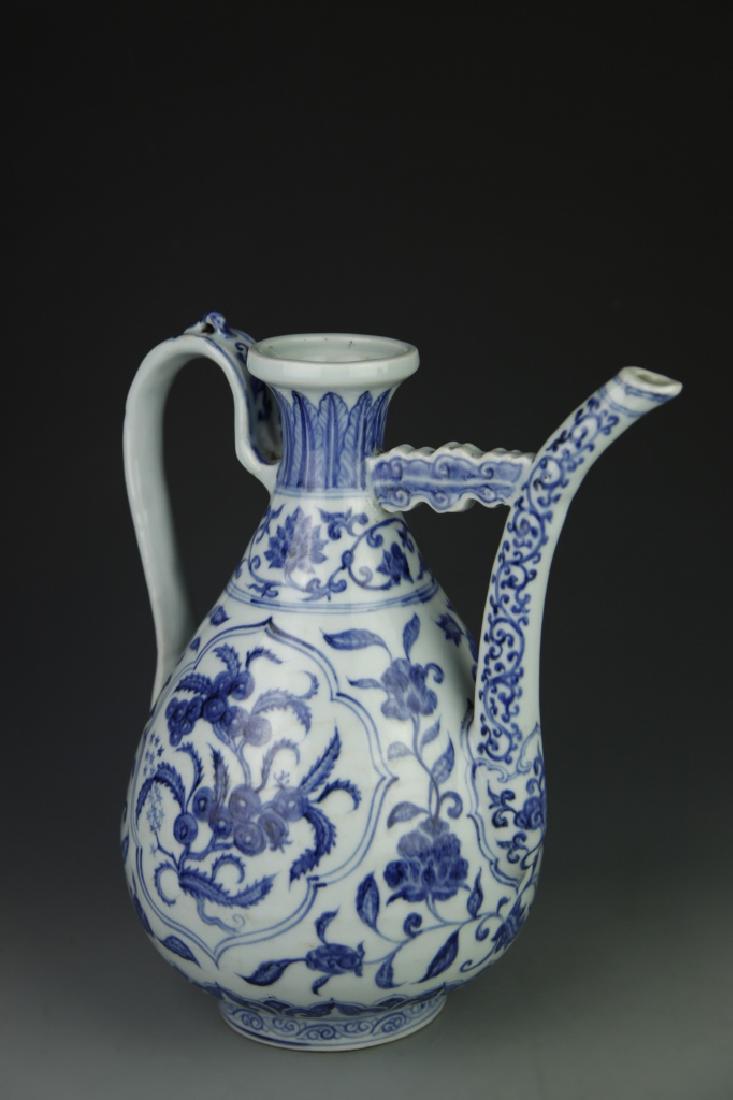 Chinese Blue And White Wine Pot: China, Ming Dynasty, Blue and White Wine Pot, bulb shaped body with looped handle and spout, blue painted decoration of floral designs and mark on base. Height 12 1/2 in.