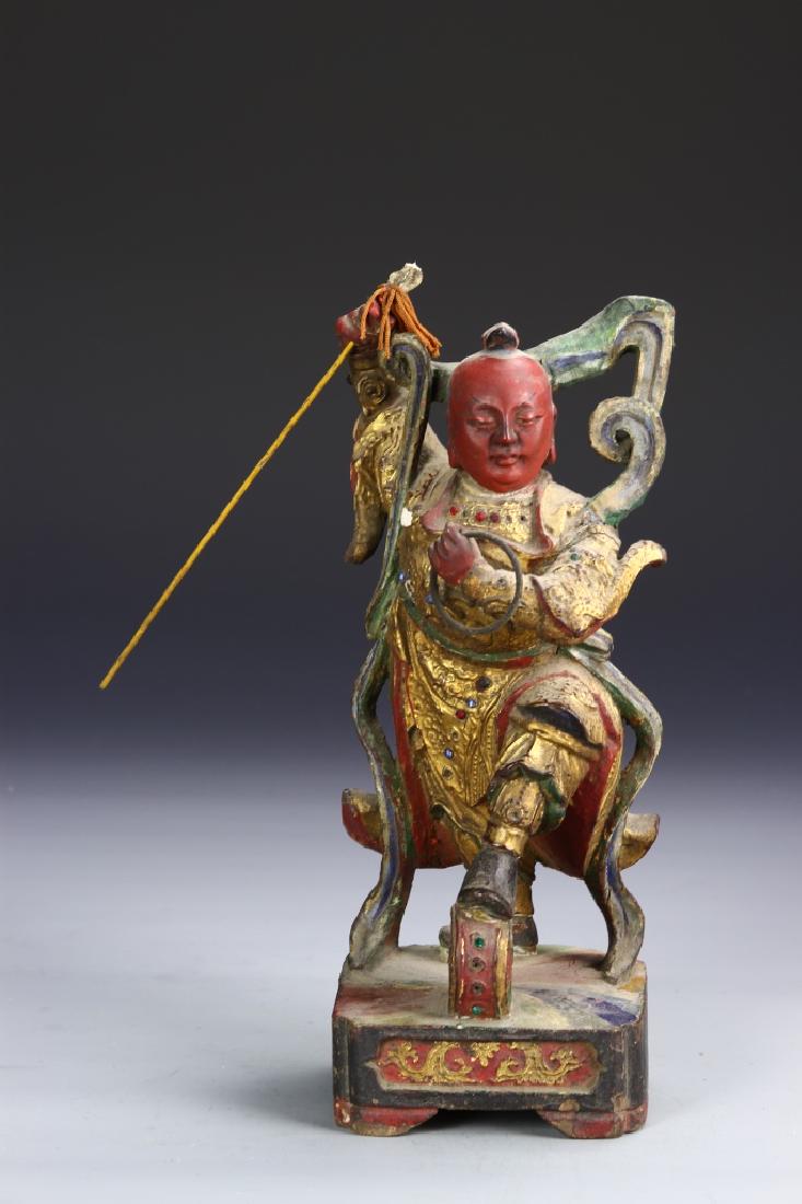 Chinese Gilt Wood Warrior: China, 18th C., gilt wood warrior, intricately carved figure in demonstration stance with weaponry tools and colored throughout with matte finish. Height 11 1/2 in.52575