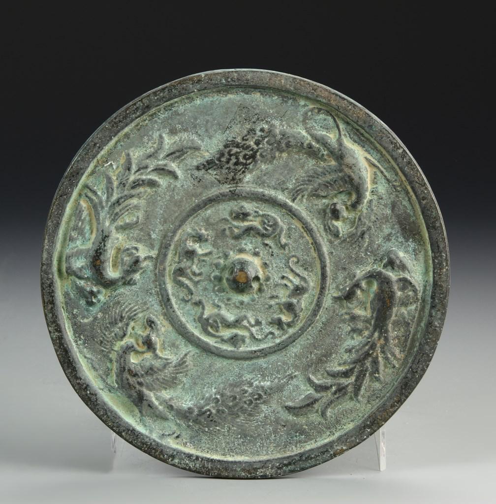 Chinese Bronze Mirror: China, antique, bronze mirror, circular body with fat base, thick rimmed border around sides, raised decoration in circular design with raised center bump. Diameter 6 in.