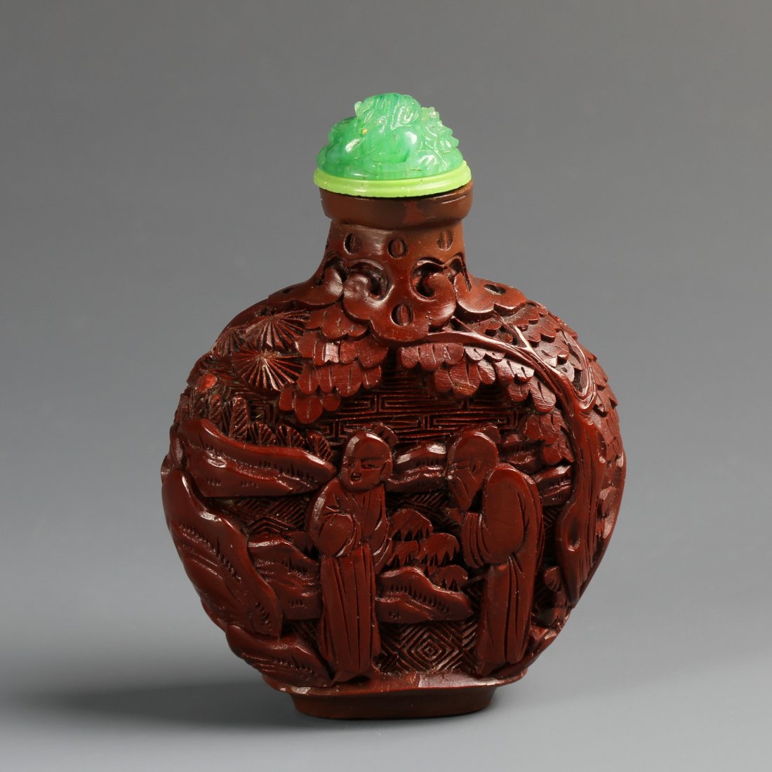 Chinese Cinnabar Snuff Bottle: China, 19th C., cinnabar snuff bottle, of pear shape, carved with figures, glass stopper. Height 3 in.