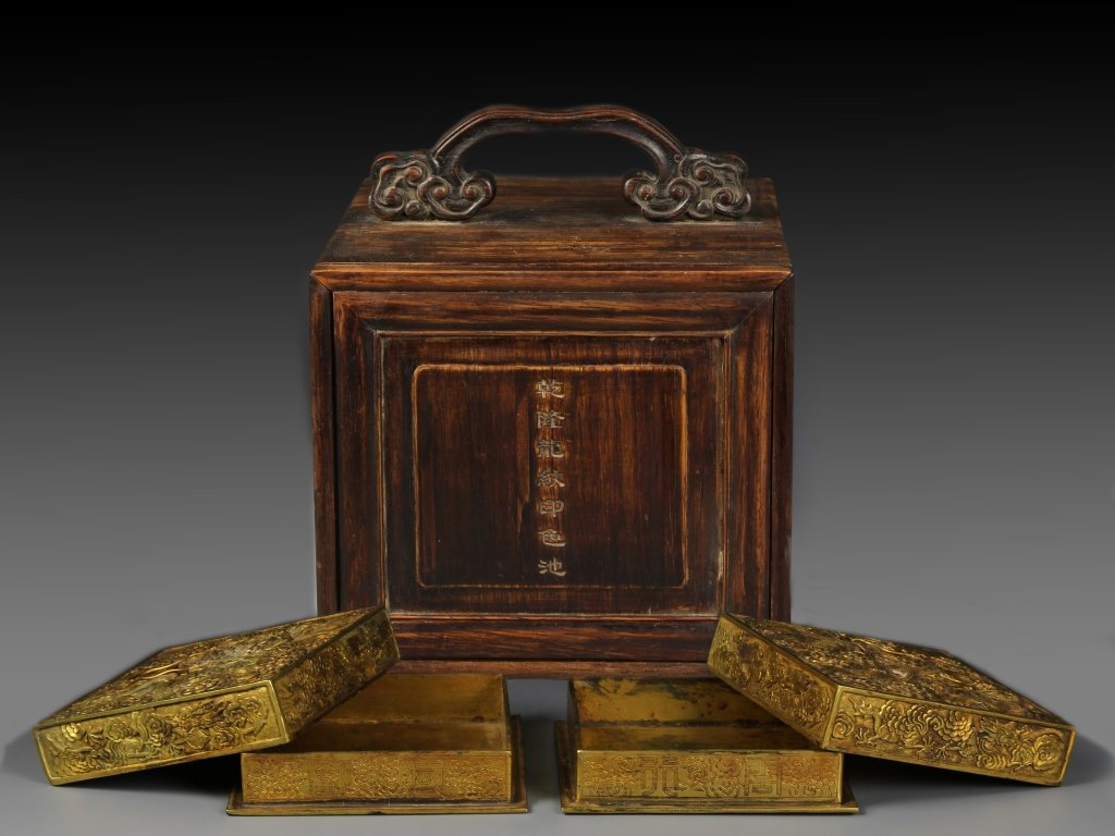 Two Chinese Gilt Seal Ink Boxes: China, 18/19th C., two gilt seal ink boxes with covers, of square form, both the covers and boxes molded and gilt with dragons and clouds designs, Qianlong mark on base and possible period, with origi