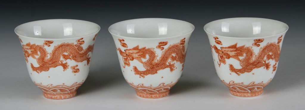 Chinese Red Dragon Wine Cups: China, 19th C., three porcelain wine cups, decorated with red dragons amid clouds and above water, Guangxu mark and of period. Height 2 1/4 in.; Width 2 3/4 in. Provenance: A private collection from a