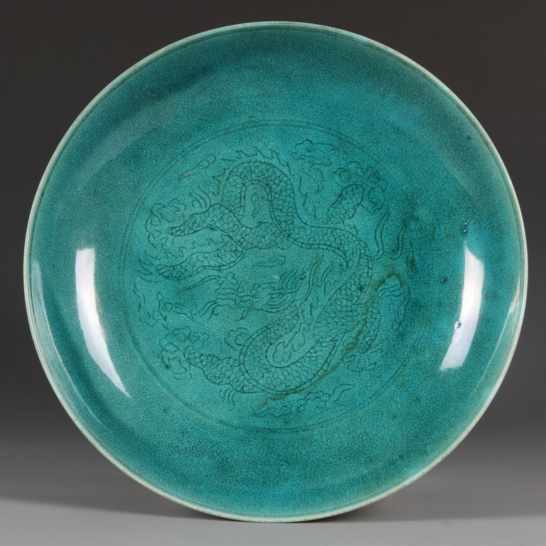 Chinese Turquoise Glazed Plate: China, Ming mark but Kangxi period, turquoise glaze plate, decorated with a leaping dragon in center , Ming Hongzhi mark on base. Diameter 6 5/8 in.