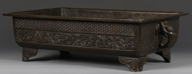 Chinese Rare Rectangular Bronze Censer: China, 19th C., very rare rectangular bronze censer, Mythical beast as handles with dragon designs cast in relief on sides, four corner footings in the form of ruyi, mark on base, dark brown patina, H