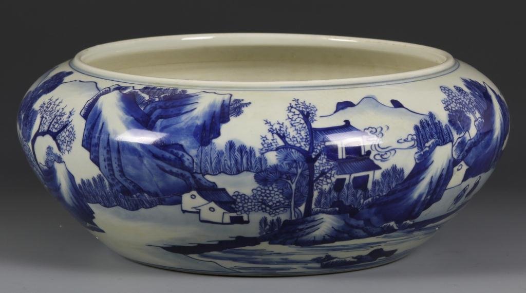 Chinese Blue and White Brush Washer: Blue and White Brush Washer, China. Scene illustrating homes set in a beautiful landscape along the water edge, some figures painted in the scene. Marking on base. (h. 4 1/4 in.; w. 9 in.)