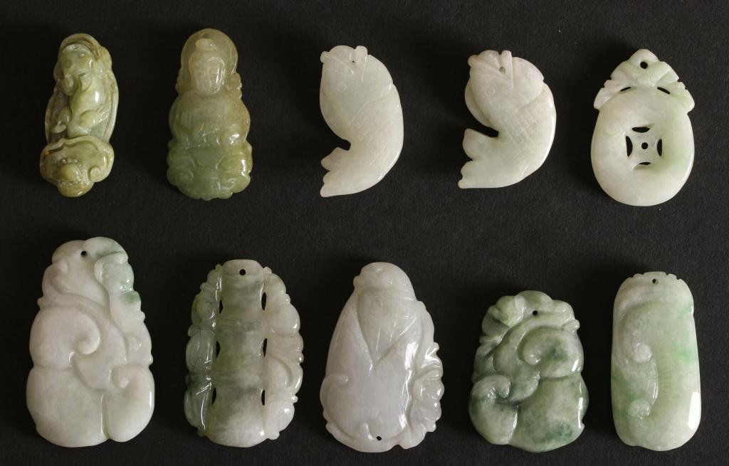 Chinese Jade Pendants: Jade Pendants (grouping), China. A variety of carved jade pendants, some in the form of fish and others in a decorative design.(l: 1 3/4 in.)