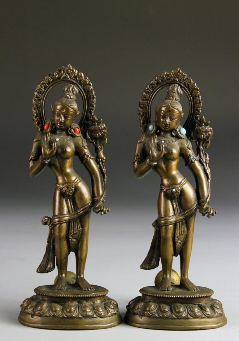 Two Indian Bronze Figures: India, 19th C., two bronze female figures with brackets on the back. Height 9 in.